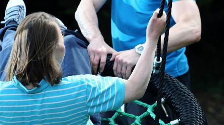 Orbis Group - playing outside on swings